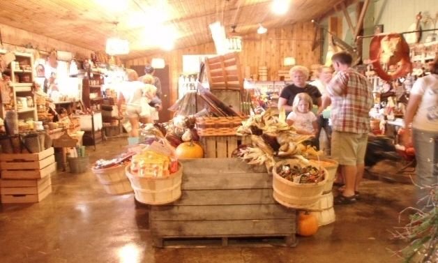 Inside the farm store with crates, pumpkins and shoppers