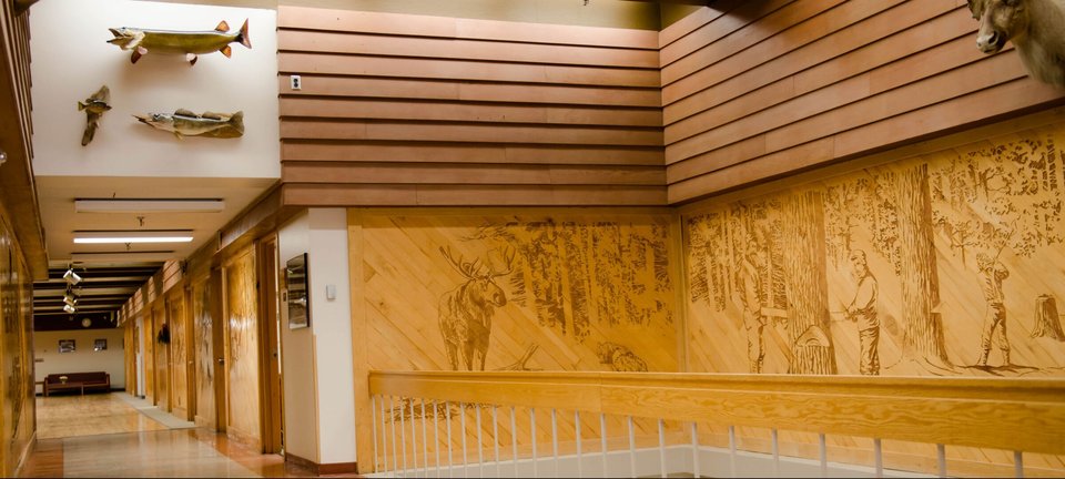 Inside the Noblet building: maple paneling and large carved wood murals