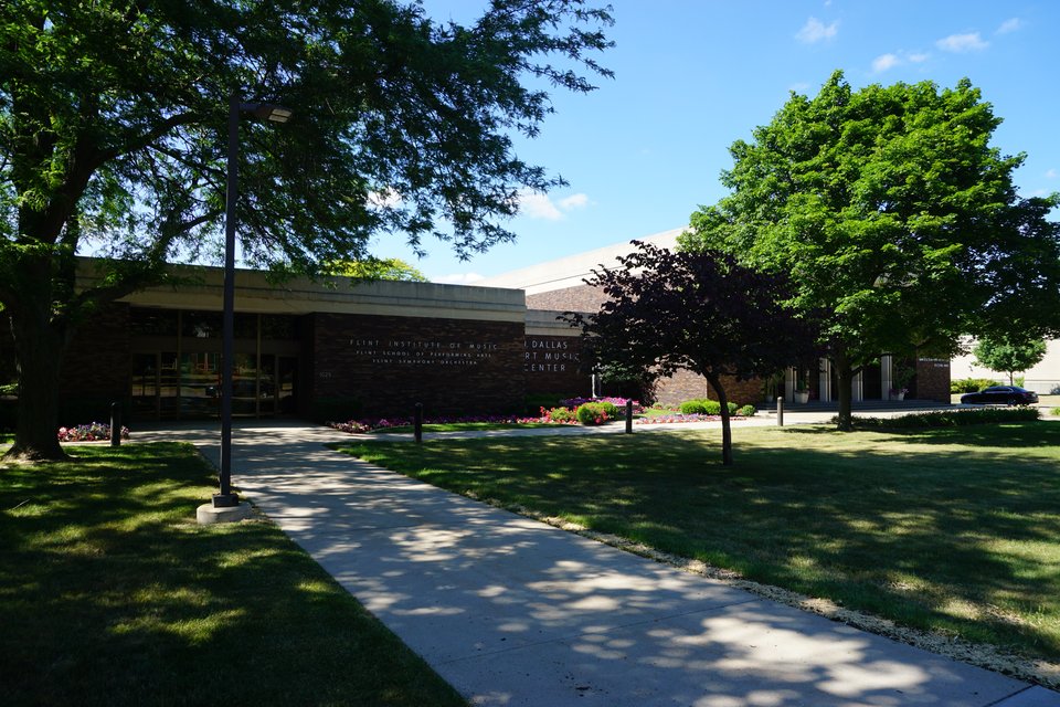 The low brick Dort Music Center building beside trees and a walkway