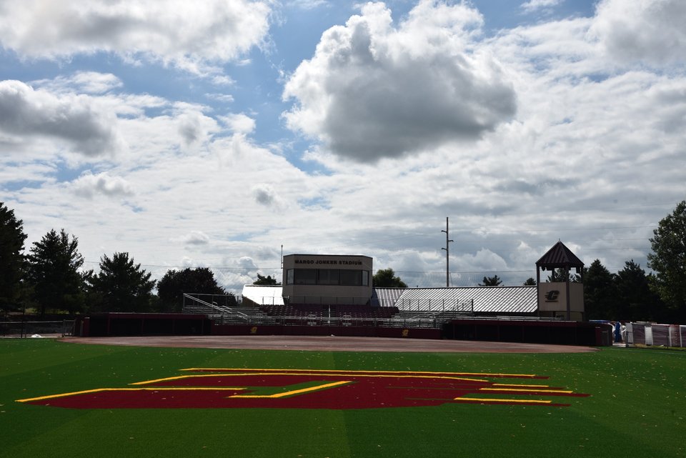 The field from the outfield, the maroon-and-gold CMU C in the grass and the press box beyond