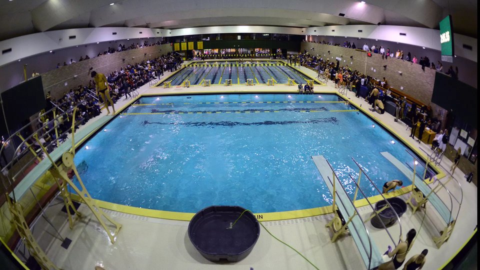 A swim meet with full stands and the diving boards in front