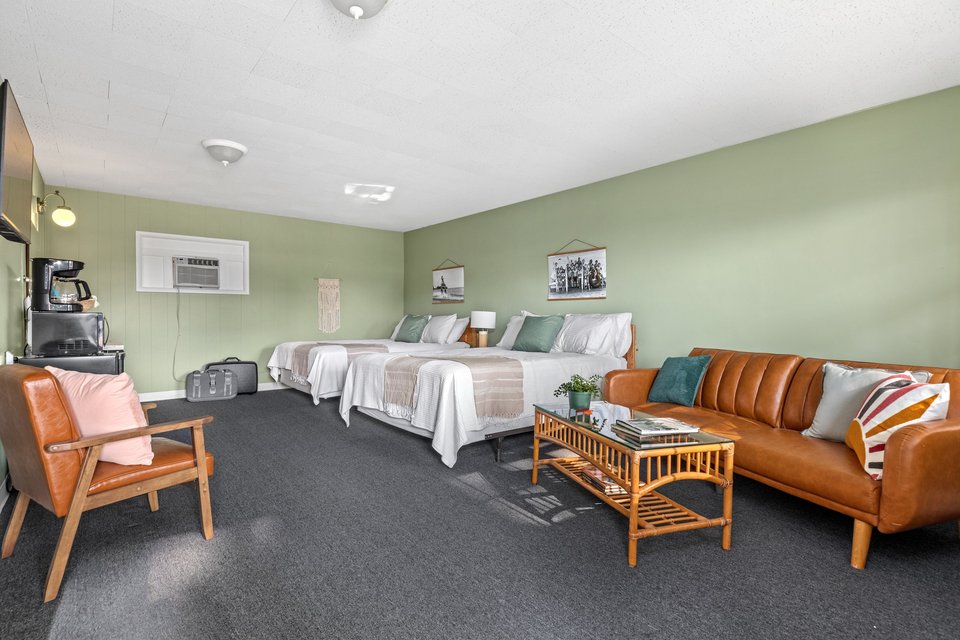 Social Suite with two queen beds and an orange sofa