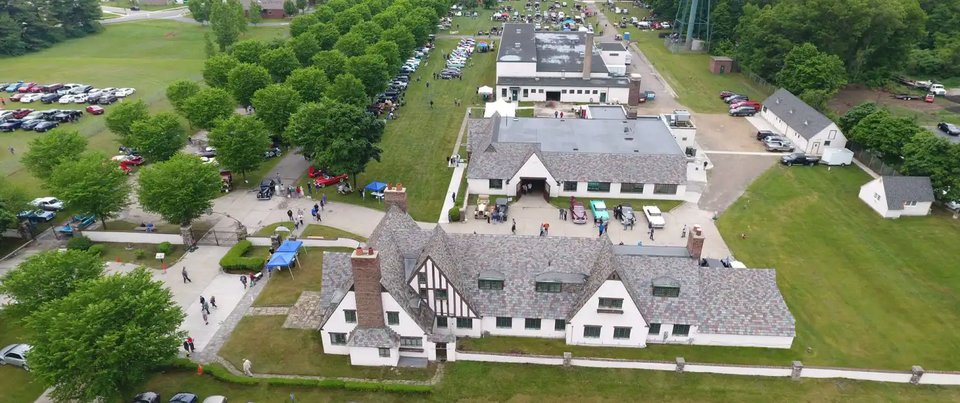 Aerial view of the historic building complex and its parking lot