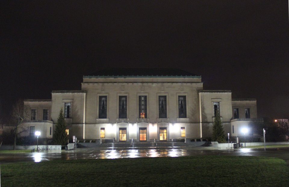 The Rackham Building lit up on a rainy winter night