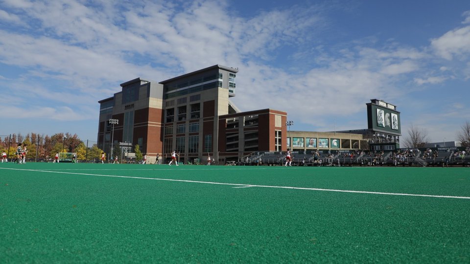 Ralph Young Field's turf and stands with the Spartan Stadium tower behind