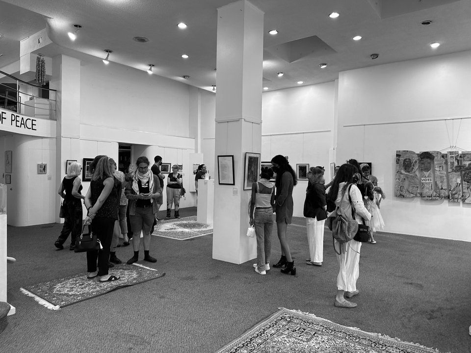 Visitors looking at the artwork during an exhibition