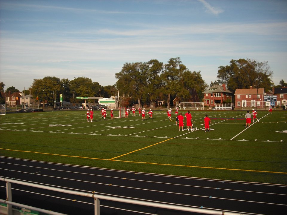 Players on Titan Field, with the running track in front
