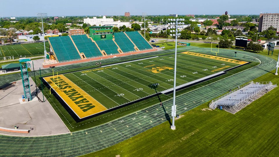 Aerial view of the stadium, its turf field and the track