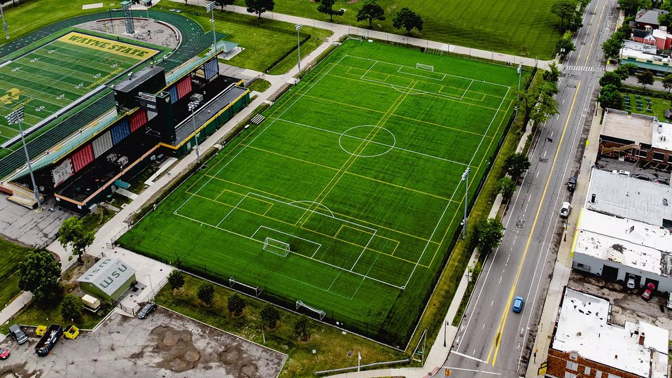 Aerial view of the soccer field with the street and stadium alongside