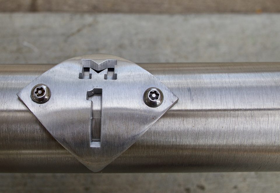 The M-1 Rail badge on a railing at Campus Martius (2017)