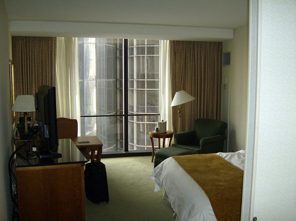 A Marriott guest room at the Renaissance Center, with a neighboring tower’s glass cylinder outside the window (2008)