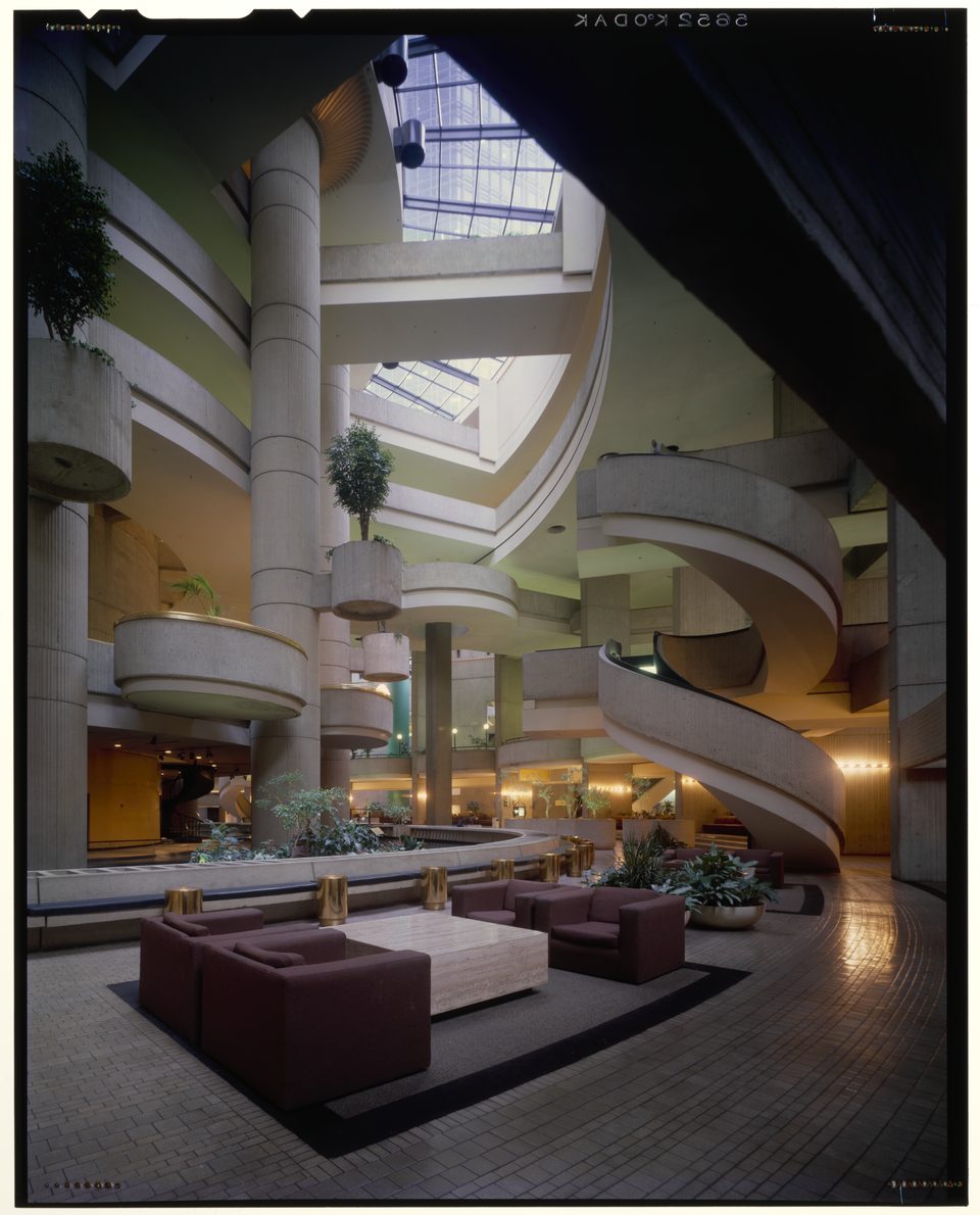Inside in 1977: concrete columns, spiraling galleries, a skylight and a burgundy seating area, photographed by Budapest-born Balthazar Korab