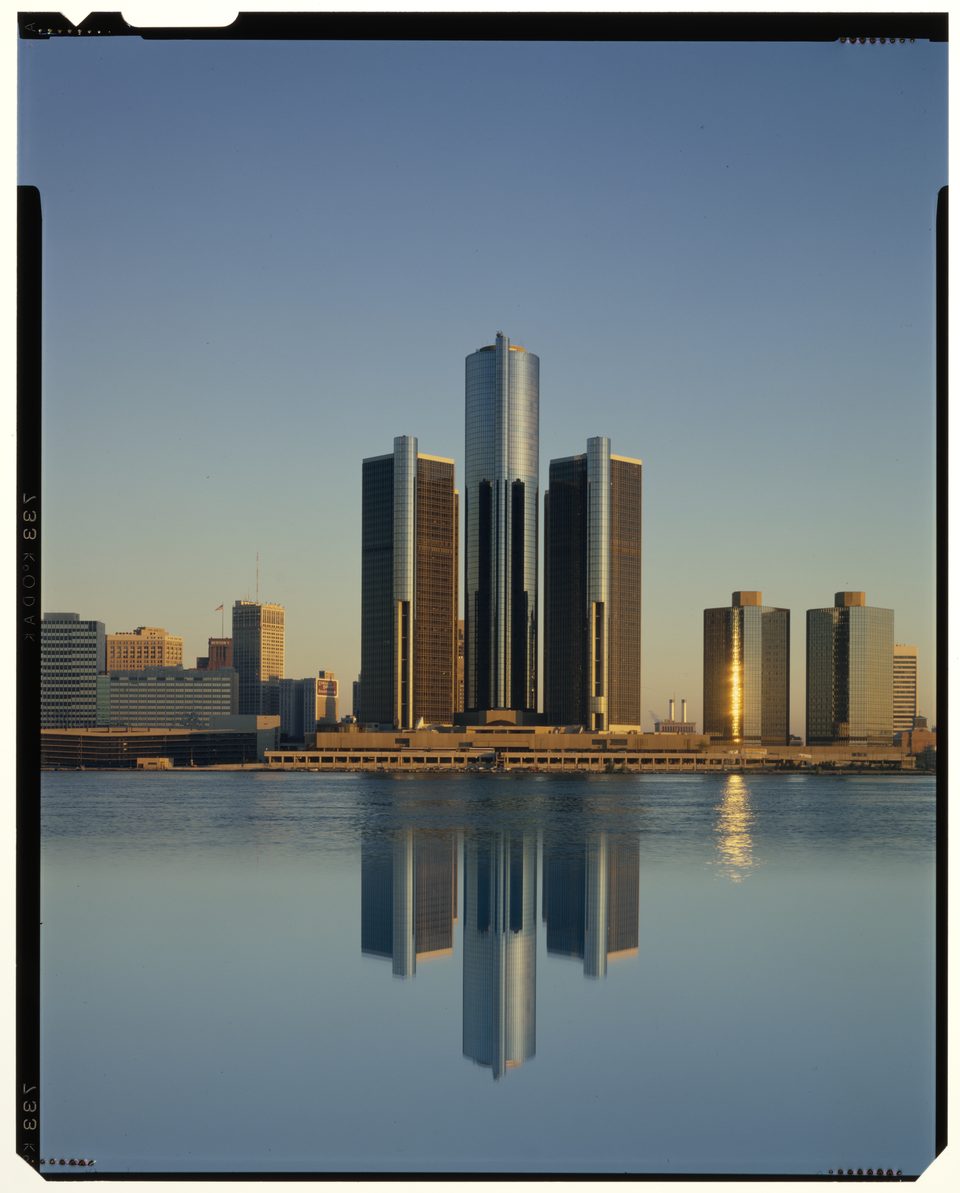 The Renaissance Center mirrored in the river, with the two shorter east towers finished in 1981 already on the right: a post-1981 photo by Budapest-born Balthazar Korab