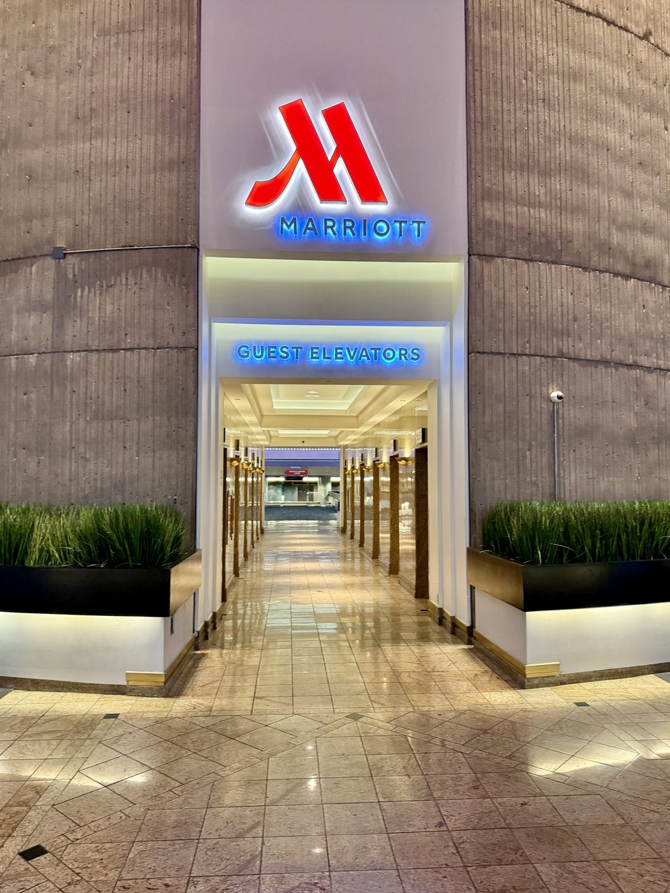 The Detroit Marriott entrance and the corridor to the guest elevators at the foot of the concrete cylinder (2024)