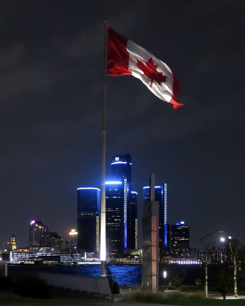 The Great Canadian Flag in Windsor’s Dieppe Gardens, with the blue-lit Renaissance Center across the river (2022)
