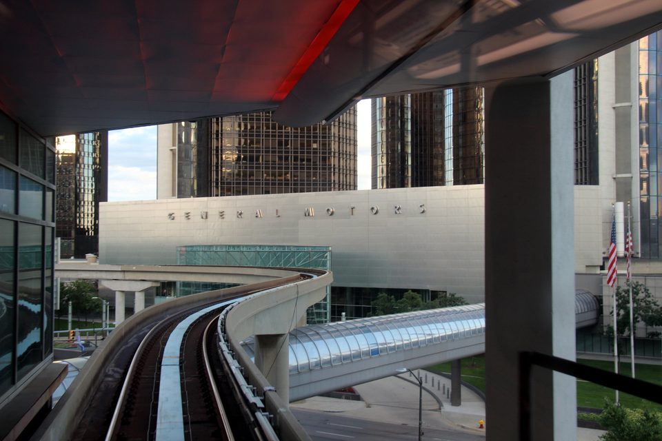 The view from a train pulling out of the Renaissance Center station, facing the podium lettered “General Motors” (2013)