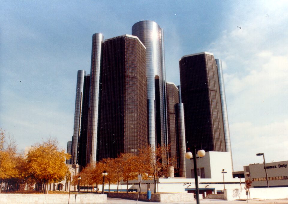 The Renaissance Center behind fall trees in October 1987, long before GM bought it in 1996 and made it its headquarters