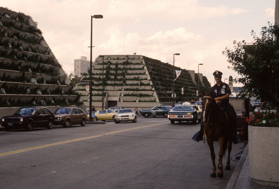 A mounted police officer outside the Renaissance Center on July 14, 1980, during the Republican National Convention, with the planted, stepped concrete berms along Jefferson Avenue behind