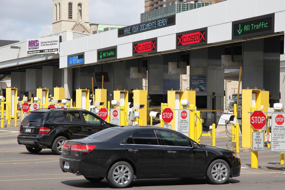 Cars from the tunnel at the Detroit port of entry inspection booths in April 2013, with the Mariners’ Church tower behind