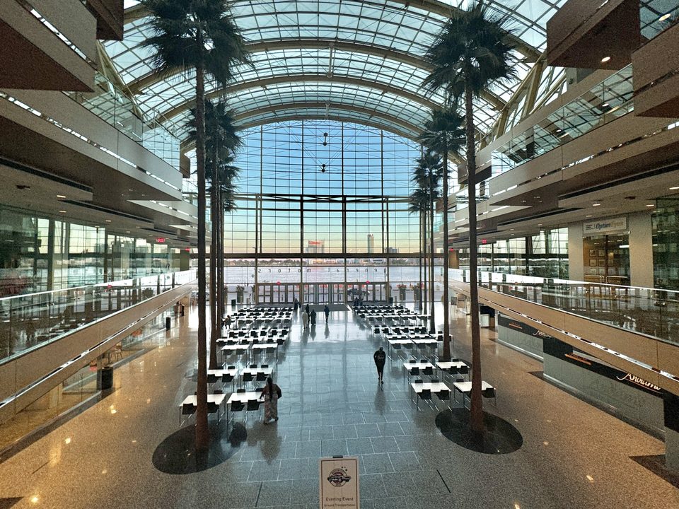 Palms and tables in the Wintergarden, with the river beyond the huge glass wall (2024)