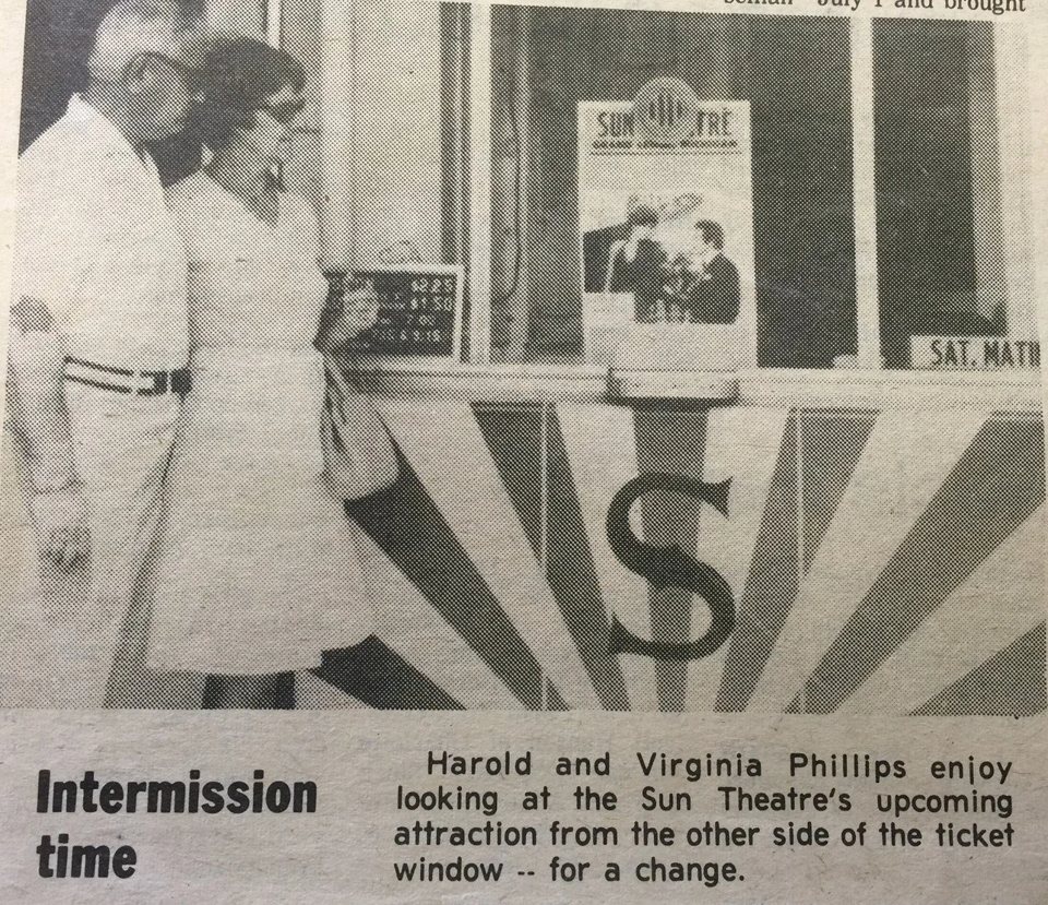 An old newspaper photo of a couple at the Sun Theatre ticket window, with a sunburst S emblem below the booth