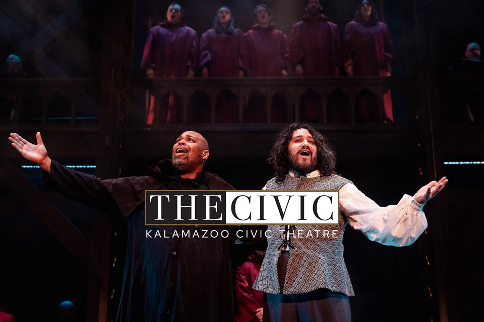 Two costumed actors sing with arms outstretched on stage while a robed choir stands on the gallery above, with THE CIVIC logo in the center