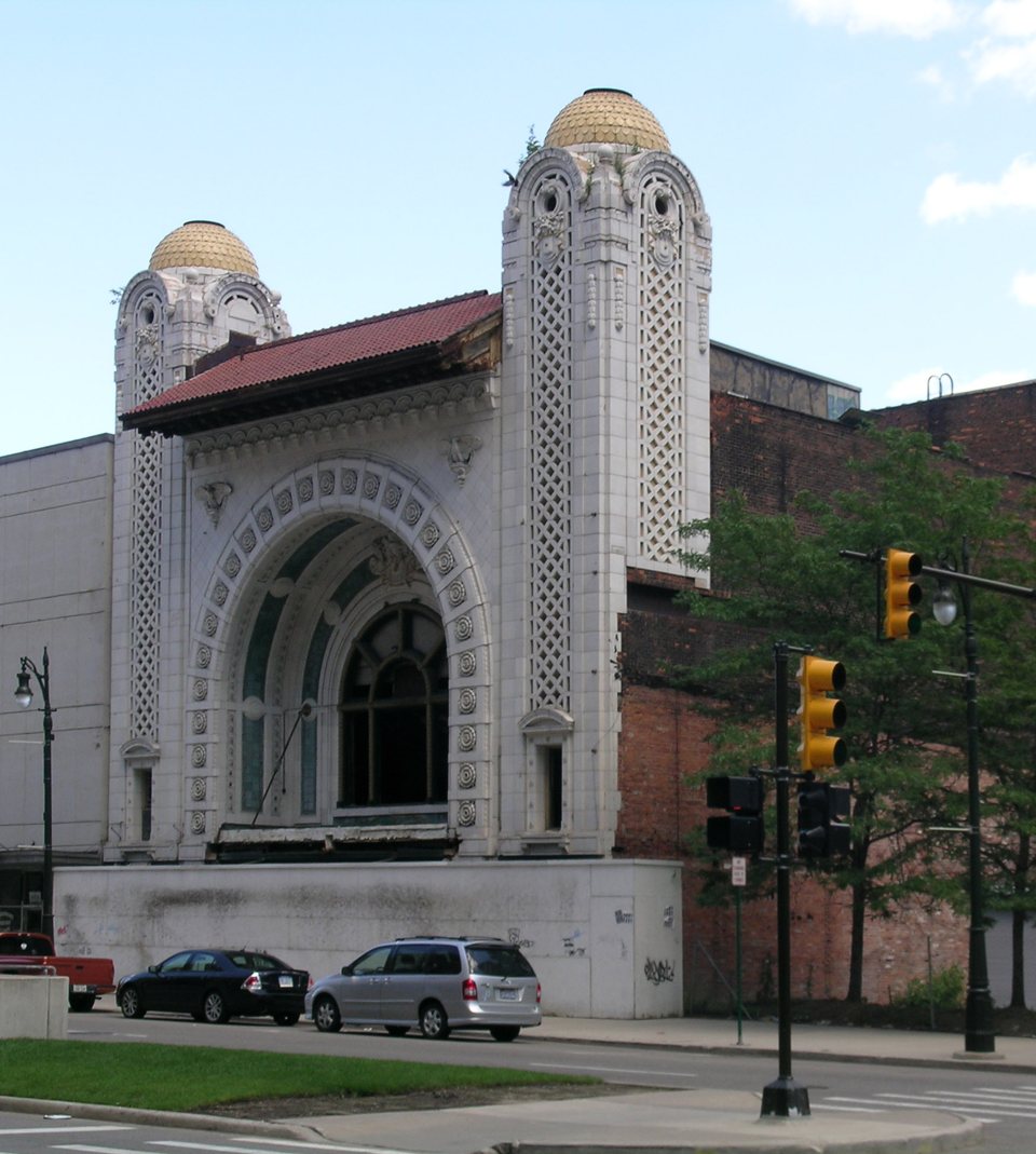 The shuttered National Theatre's white terracotta facade with two gold-domed towers and a grand arched entrance on Monroe Street