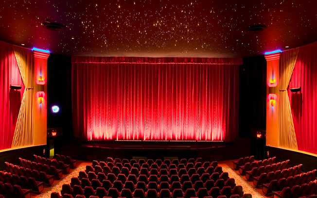 The auditorium with red curtains, a starry ceiling and red seats