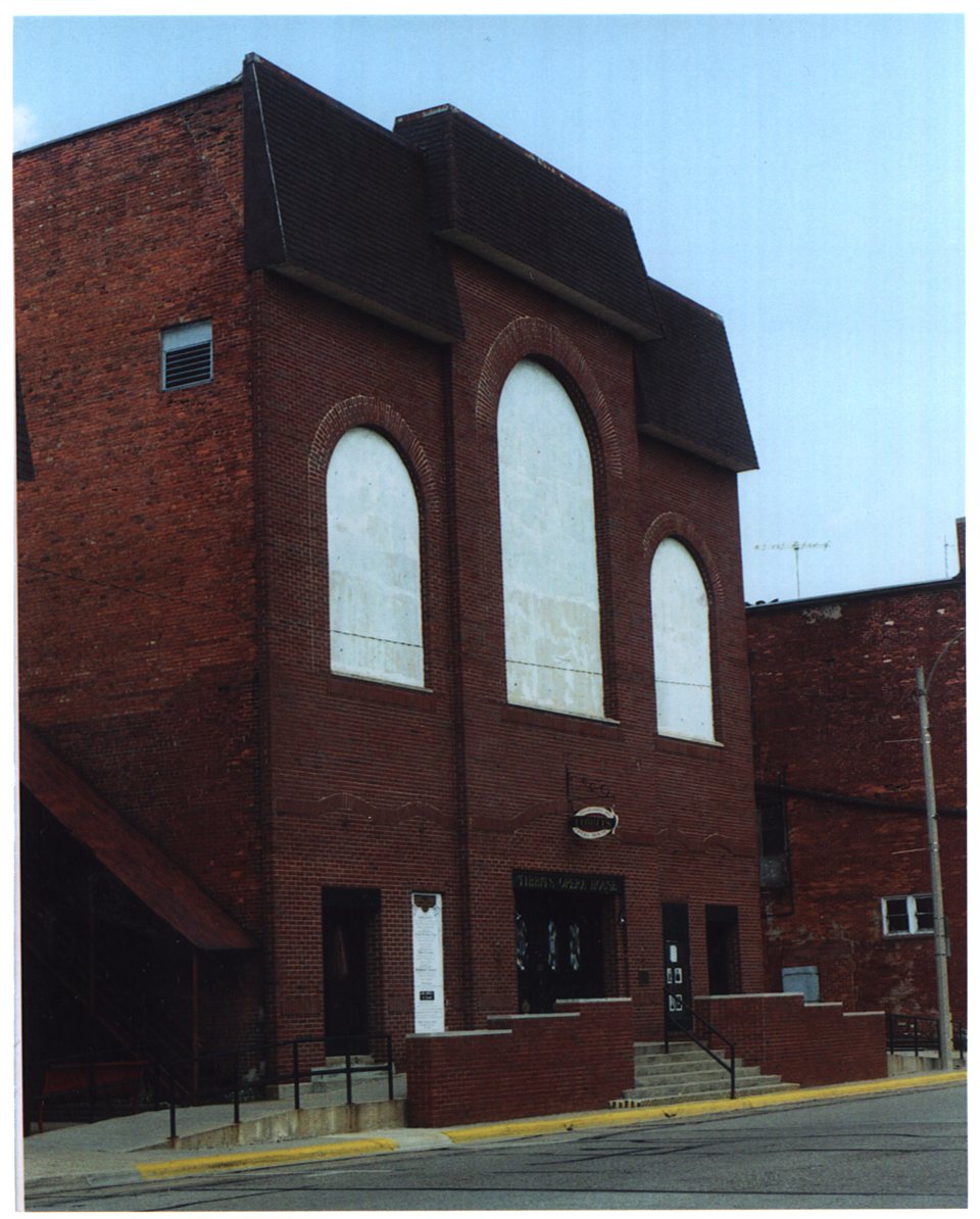 The opera house's simplified 1960s brick facade with its filled-in arched windows