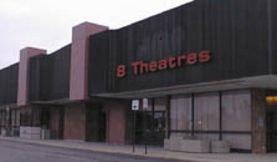 The cinema's low, dark-clad building with the red 8 Theatres lettering
