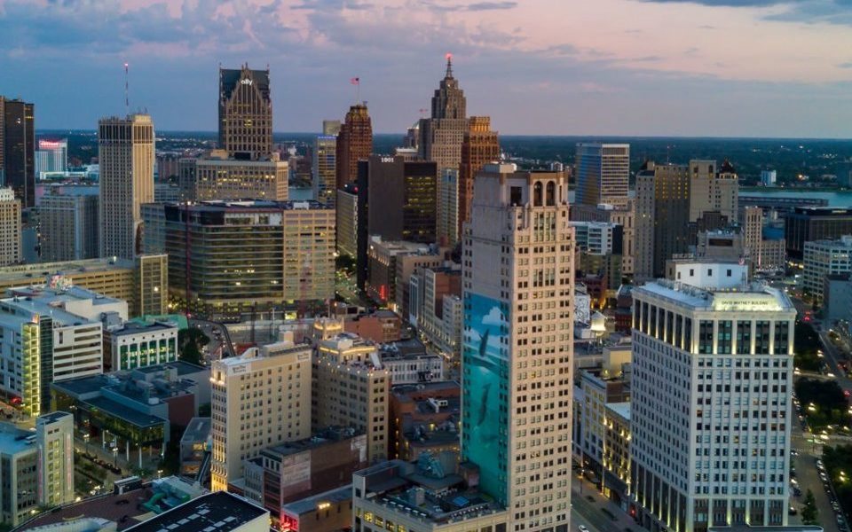 Aerial view of downtown Detroit at dusk with its skyline lit up