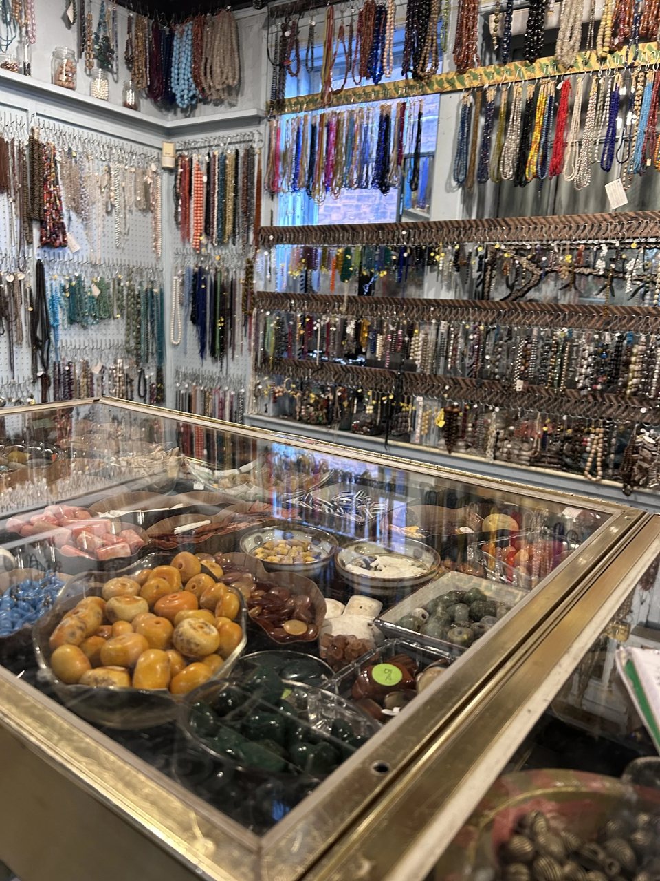 Inside the shop, shelves are packed with colorful beaded necklaces and jewelry