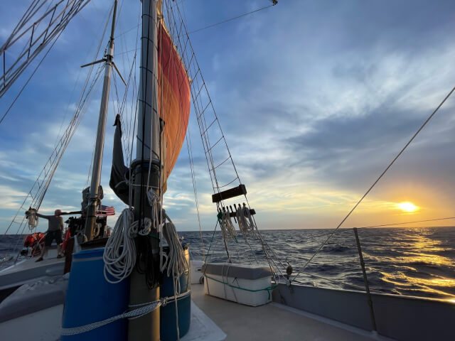 Sunset view alongside the mast and orange sail