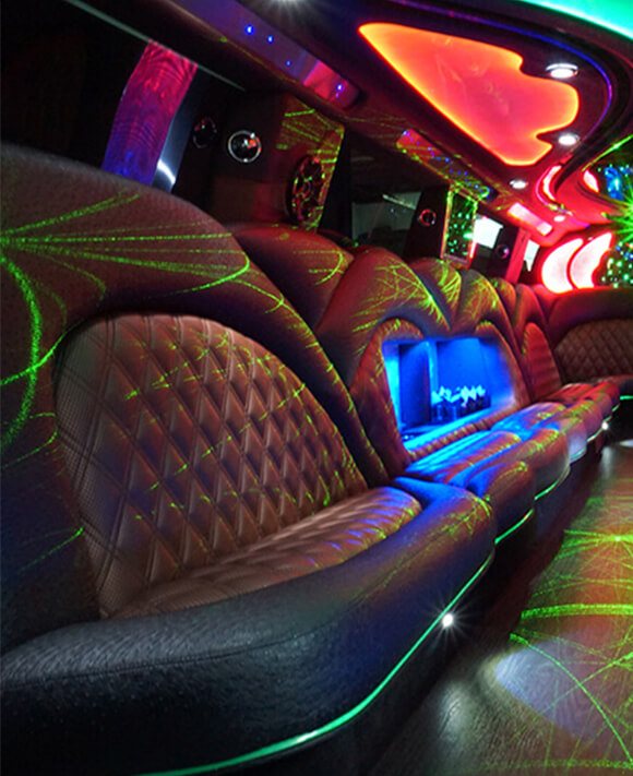 Red and green laser lights illuminate the leather seating inside the party trolley