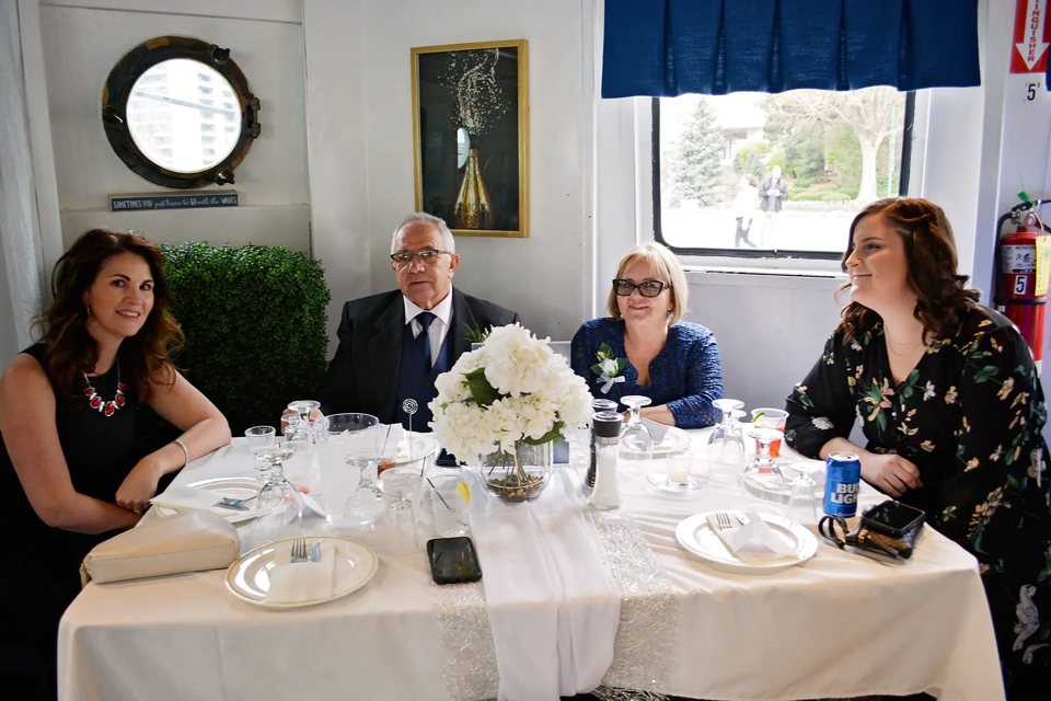 Guests dine together aboard the ship's deck